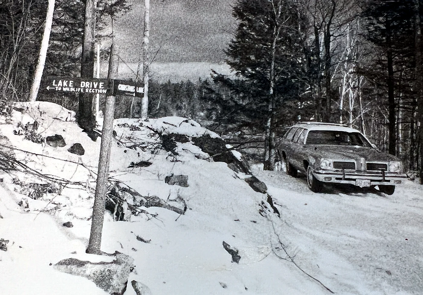 The old Christmas Lane and Lake Drive sign at the top of the hill, in winter.